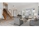 Bright living room with hardwood floors, large windows, and cozy seating, creating an inviting atmosphere at 16420 Martingale Dr, Parker, CO 80134