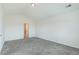 Neutral bedroom featuring a vaulted ceiling, plush carpeting, and a door leading to a closet or bathroom at 2552 W 82Nd Ln # C, Westminster, CO 80031