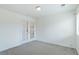 Bright bedroom with neutral walls, newer carpet, and double doors at 2552 W 82Nd Ln # C, Westminster, CO 80031