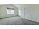 Bright bedroom with a window, vaulted ceilings, plush carpeting, and access to a balcony or patio at 2552 W 82Nd Ln # C, Westminster, CO 80031