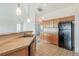 Bright kitchen with wood cabinetry and black appliances at 2552 W 82Nd Ln # C, Westminster, CO 80031