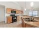 Open-concept kitchen with wood cabinets and a breakfast bar at 2552 W 82Nd Ln # C, Westminster, CO 80031