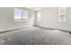Spacious bedroom with large windows, carpet flooring, and neutral walls at 564 Penn Rd, Elizabeth, CO 80107