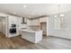 Modern kitchen with white cabinets, stainless steel appliances, and a large center island at 564 Penn Rd, Elizabeth, CO 80107