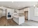 Bright, modern kitchen features white cabinets, stainless appliances, and a large center island at 564 Penn Rd, Elizabeth, CO 80107