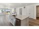 Spacious kitchen with a large center island, stainless steel appliances, and a view to the living area at 564 Penn Rd, Elizabeth, CO 80107