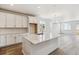 Contemporary kitchen featuring white cabinets, large center island, and an open floor plan at 564 Penn Rd, Elizabeth, CO 80107