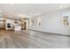 Open-concept living space with a view into the spacious kitchen with stainless appliances at 564 Penn Rd, Elizabeth, CO 80107