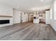 Open-concept living space with a modern fireplace and a view into the spacious kitchen at 564 Penn Rd, Elizabeth, CO 80107
