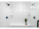 Modern shower featuring dual shower heads, built-in bench, and sleek tile at 385 East St, Louisville, CO 80027