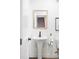 Chic powder room with pedestal sink, decorative mirror, and modern fixtures at 385 East St, Louisville, CO 80027