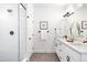 Modern bathroom with double sink vanity, sleek fixtures, and glass-enclosed shower at 385 East St, Louisville, CO 80027