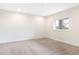 Bright, empty bedroom with neutral carpet, a window bringing in natural light, and a clean, simple design at 385 East St, Louisville, CO 80027