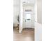 Bright foyer with a white front door, light wood floors, and minimalist decor at 385 East St, Louisville, CO 80027