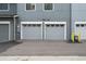 View of the home's garages, featuring modern doors and neutral color palette, providing ample parking and storage at 385 East St, Louisville, CO 80027