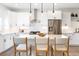 Bright kitchen island featuring white countertops, stainless steel appliances, and bar seating at 385 East St, Louisville, CO 80027