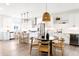 Bright kitchen with stainless steel appliances, white cabinetry, and cozy dining space at 385 East St, Louisville, CO 80027