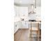 Bright kitchen features white cabinetry, stainless steel appliances, and subway tile backsplash at 385 East St, Louisville, CO 80027