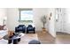 Sunlit living room with contemporary furnishings and a view of lush greenery at 385 East St, Louisville, CO 80027