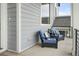 Inviting outdoor seating area with comfortable blue chairs and decorative pillows on front porch at 385 East St, Louisville, CO 80027