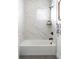 Modern bathroom featuring a tub and shower with stylish tile surround, black fixtures, and a sleek design at 385 East St, Louisville, CO 80027