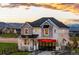 Stunning two-story home featuring a red awning, landscaped yard, and mountain views at 8958 Whiteclover St, Littleton, CO 80125