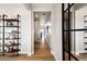 Bright hallway featuring wood floors, modern shelving, and an abundance of natural light at 8958 Whiteclover St, Littleton, CO 80125