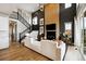 Sophisticated living room featuring a fireplace, high ceilings, and an open staircase at 8958 Whiteclover St, Littleton, CO 80125