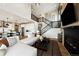 Bright, open-concept living room adjacent to the modern kitchen and featuring an open staircase at 8958 Whiteclover St, Littleton, CO 80125