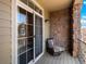 Balcony area, featuring a striped chair and sliding glass doors with a view at 15496 W 66Th Dr # B, Arvada, CO 80007