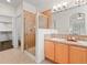 Bathroom with glass shower, double sink vanity, and walk-in closet at 15496 W 66Th Dr # B, Arvada, CO 80007