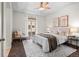 Charming bedroom with a balcony view, two bedside lamps, and neutral decor creates a cozy and inviting space at 15496 W 66Th Dr # B, Arvada, CO 80007