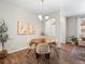Cozy dining room with stylish furniture, hardwood floors, elegant light fixture, and sophisticated decor at 15496 W 66Th Dr # B, Arvada, CO 80007