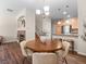 Lovely dining area with a round table set, decorative lighting, and seamless flow into the kitchen space at 15496 W 66Th Dr # B, Arvada, CO 80007