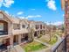 Exterior view of townhomes with landscaped yards and walkways at 15496 W 66Th Dr # B, Arvada, CO 80007