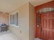 Close-up of a well-crafted front door with sidelight, set within a siding and brick entryway and outdoor grill at 15496 W 66Th Dr # B, Arvada, CO 80007