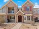 Charming stone townhome with a well-maintained front yard, covered balcony, and inviting front entrance at 15496 W 66Th Dr # B, Arvada, CO 80007