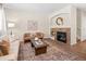 Cozy living room with a fireplace, plush seating, decorative rug, and an open, inviting atmosphere at 15496 W 66Th Dr # B, Arvada, CO 80007