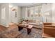 Bright living room featuring stylish furniture, hardwood floors, a large window, and sophisticated decor at 15496 W 66Th Dr # B, Arvada, CO 80007