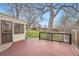 Home featuring wood deck overlooking a large backyard with mature trees and a garden at 3245 S Nucla St, Aurora, CO 80013