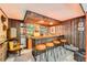 Retro basement bar with orange bar stools, wood paneling, and vintage decor at 3245 S Nucla St, Aurora, CO 80013