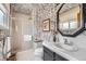 Contemporary bathroom with a glass-enclosed shower, modern fixtures, and unique mosaic tiling throughout at 3245 S Nucla St, Aurora, CO 80013