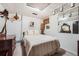 Cozy bedroom with striped bedding, neutral walls, and vintage decor accents at 3245 S Nucla St, Aurora, CO 80013