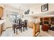 Open dining area with a glass table, wooden chairs, and views into the living room at 3245 S Nucla St, Aurora, CO 80013