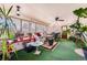 Bright sunroom with ample windows, plants, ceiling fan and door to the back yard at 3245 S Nucla St, Aurora, CO 80013