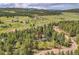 Aerial view of a house with a red arrow pointing to its location in the neighborhood at 7753 Red Fox Dr, Evergreen, CO 80439