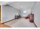 A spacious basement featuring carpeted floors, a desk, a chair, and a small window at 7753 Red Fox Dr, Evergreen, CO 80439