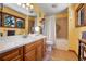 Bathroom with a double vanity, tile floors, and a shower-tub combination with a white shower curtain at 7753 Red Fox Dr, Evergreen, CO 80439