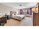 Bright bedroom with a large window, neutral carpet, a modern desk and lots of dresser storage at 7753 Red Fox Dr, Evergreen, CO 80439