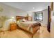 Comfortable bedroom featuring wood furnishings, hardwood floors, a window, and tasteful decor at 7753 Red Fox Dr, Evergreen, CO 80439